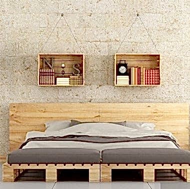 Modern bedroom with pallet bed on brick wall